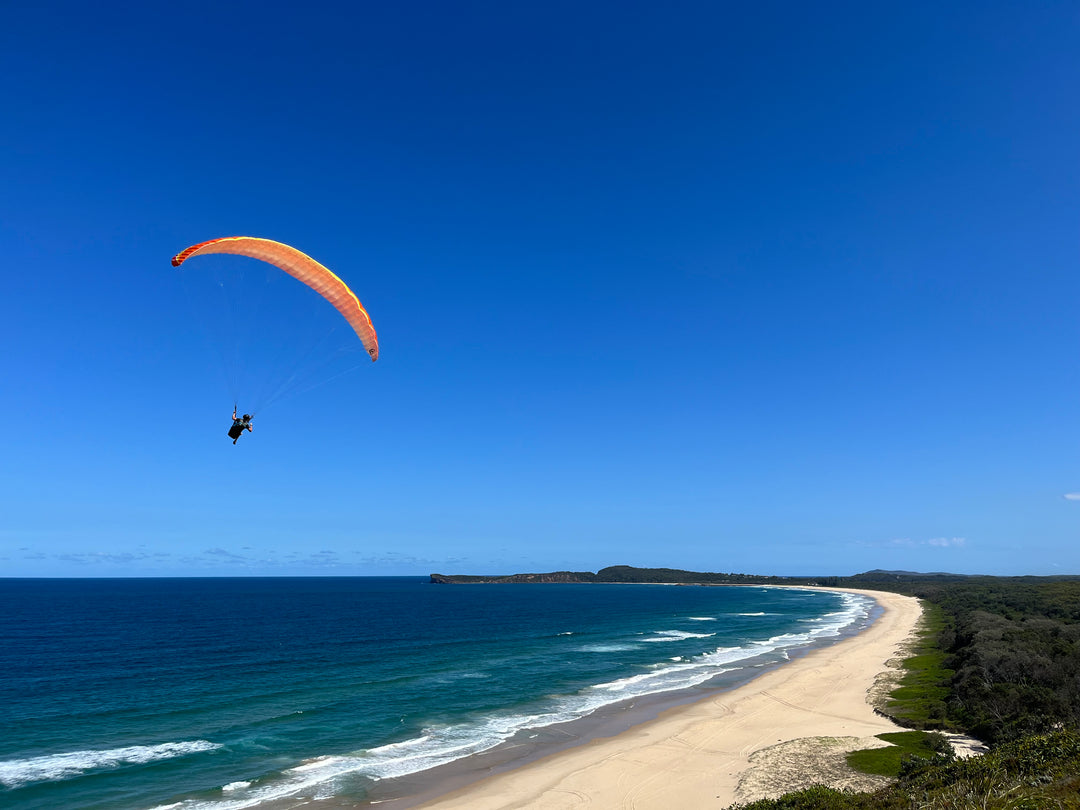 tandem paragliding flight coastal